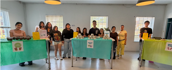 Youth entrepreneurs presenting products at program tables
